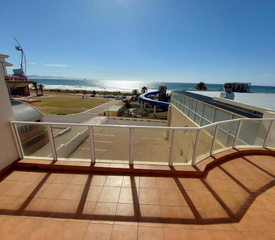 a balcony with a view of the beach at SYMSTAY Don Diaz in Jeffreys Bay