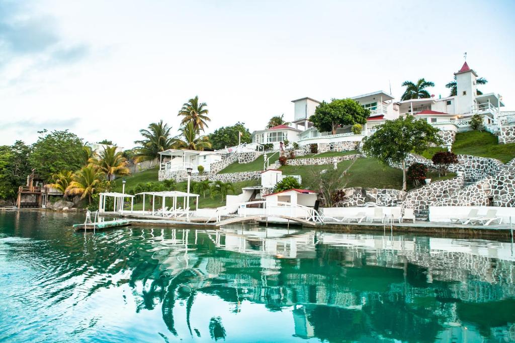 a pool of water in front of a house at Hotel Laguna Bacalar in Bacalar