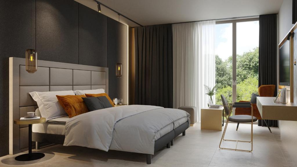 a bedroom with a large white bed and a desk at Scheck Hotel in Munich