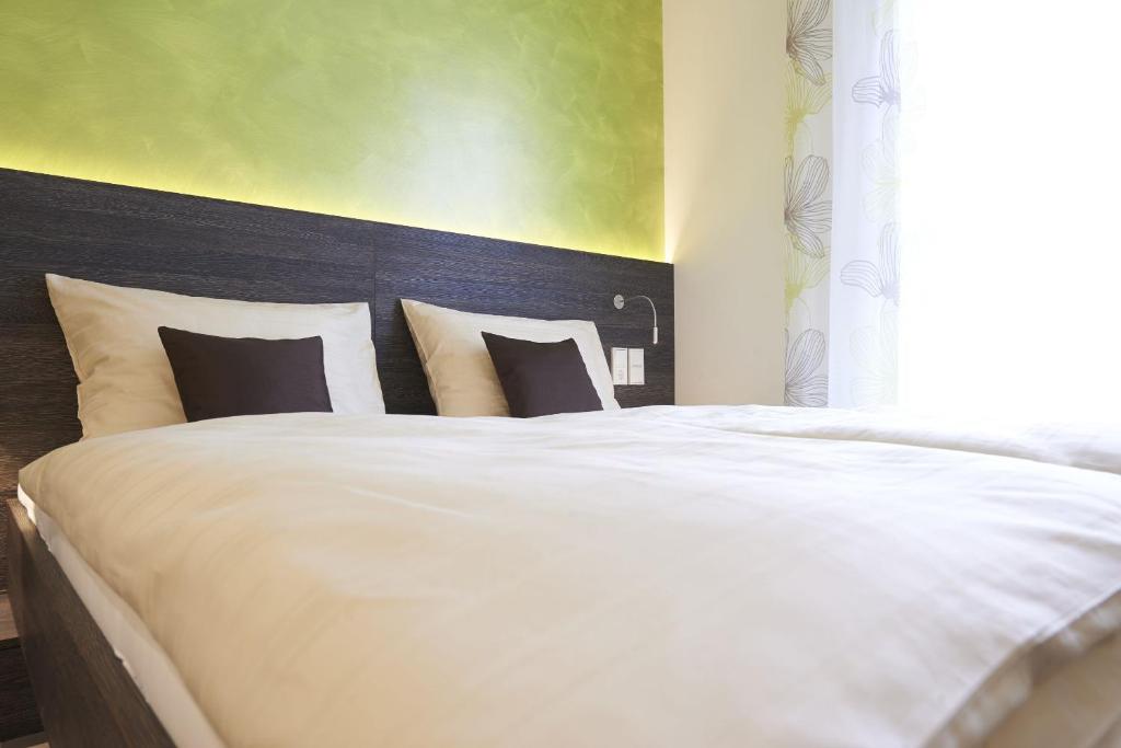 Posteľ alebo postele v izbe v ubytovaní eee Hotel Marchtrenk