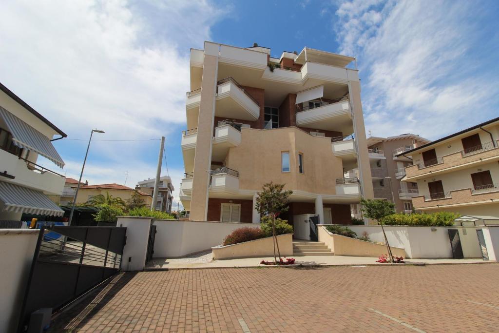a large apartment building with a brick driveway at Solemare in Tortoreto Lido