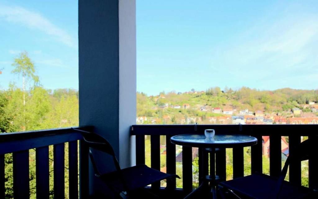 a table on a balcony with a cup of coffee on it at Fewo DUE in Naundorf