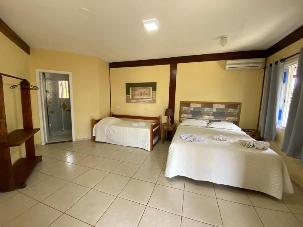1 Schlafzimmer mit 2 Betten in einem Zimmer in der Unterkunft Pousada Bonns Ventos in Ilhabela