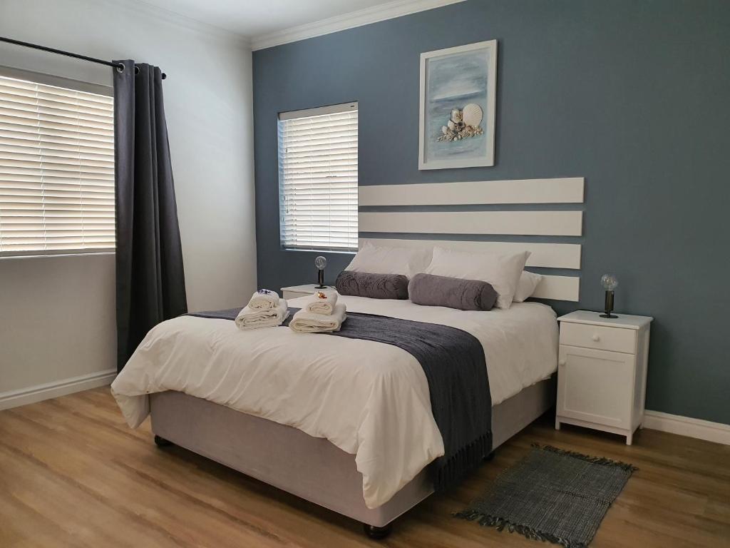 a bedroom with a bed with two towels on it at Plett57 - Self Catering - Room No1 in Plettenberg Bay