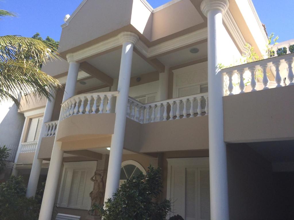 a large white house with a balcony at Villa Franca in Rio de Janeiro