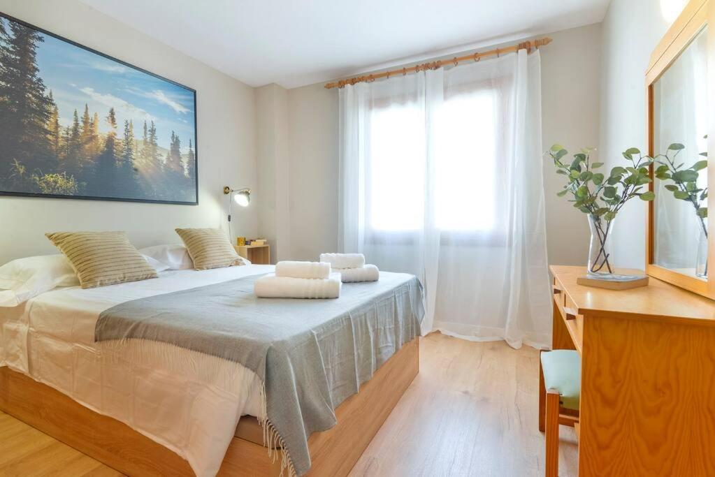 a bedroom with a bed with two towels on it at APARTAMENTO A 200 M DEL PUERTO, bonanza 15 1C in Colonia Sant Jordi