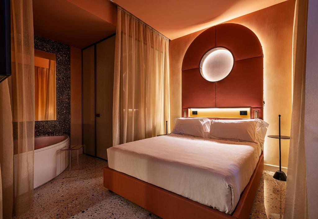 um quarto com uma cama e uma banheira em Enterprise Hotel Design & Boutique em Milão