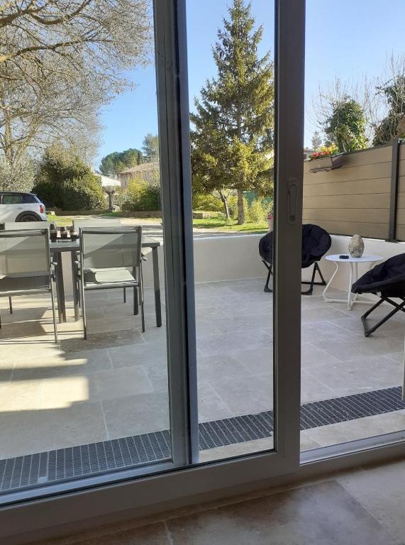 a sliding glass door with a view of a patio at Gite La vallée du silence in Le Beausset