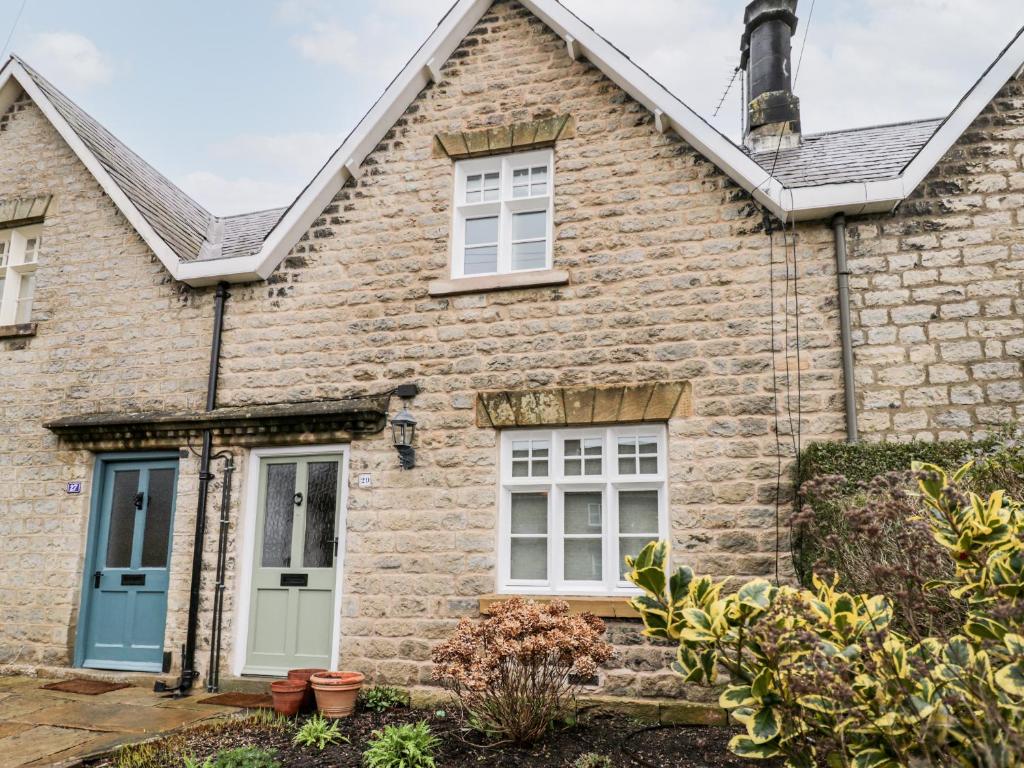 a stone house with a blue door and windows at 29 Bondgate in York