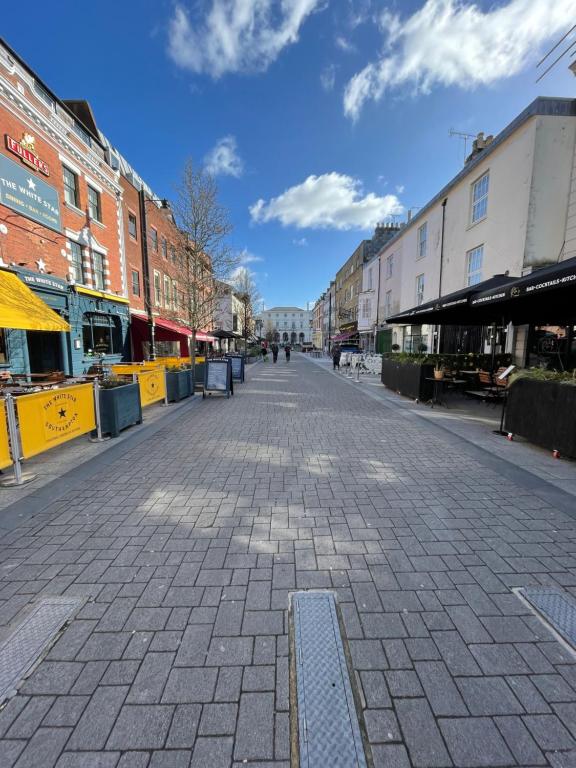 an empty street in a city with buildings at Oxford Street Stays in Southampton