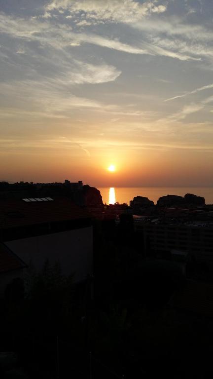 einen Sonnenuntergang über dem Meer mit der Sonne am Himmel in der Unterkunft Amazing view - Monaco in Cap d'Ail
