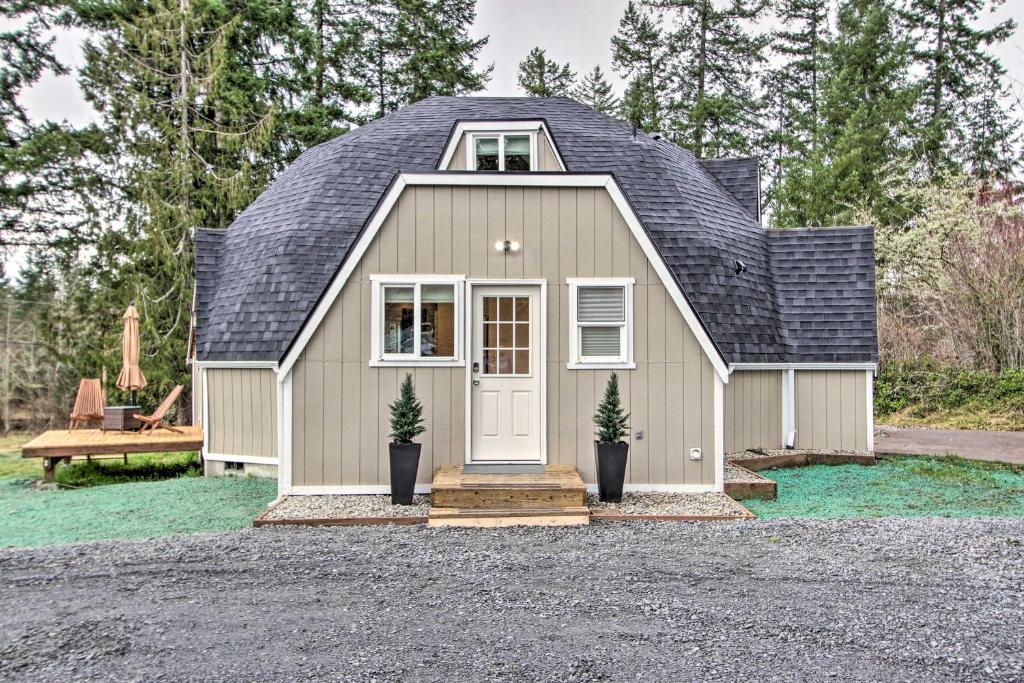 a small house with a gambrel roof at Geodesic Dome House with Scenic Views and Hot Tub in Eatonville