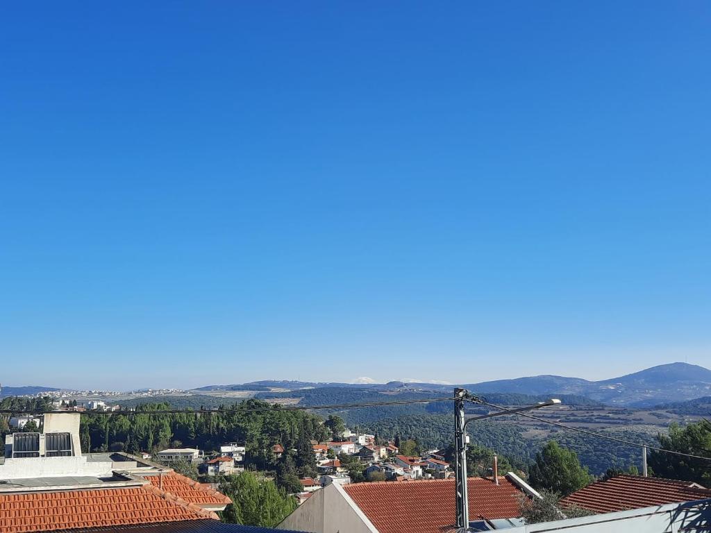 a view of a city with mountains in the background at יחידת נוף הרים Nof Harim in Ma'alot Tarshiha