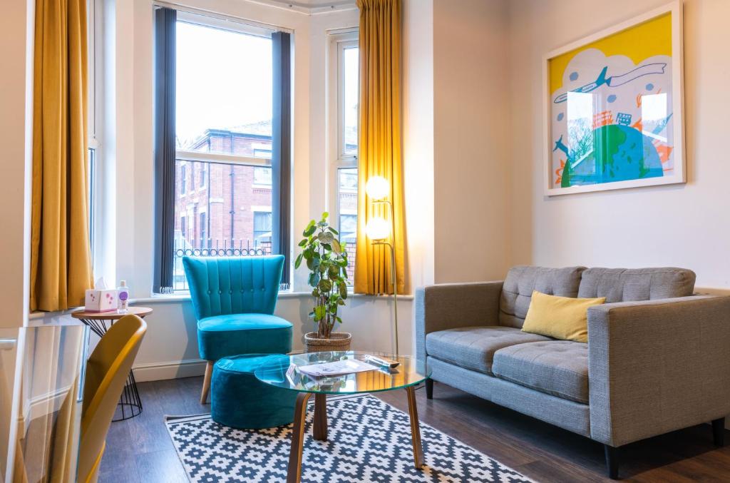 a living room with a couch and a table at Fulwood Heights Apartments in Preston