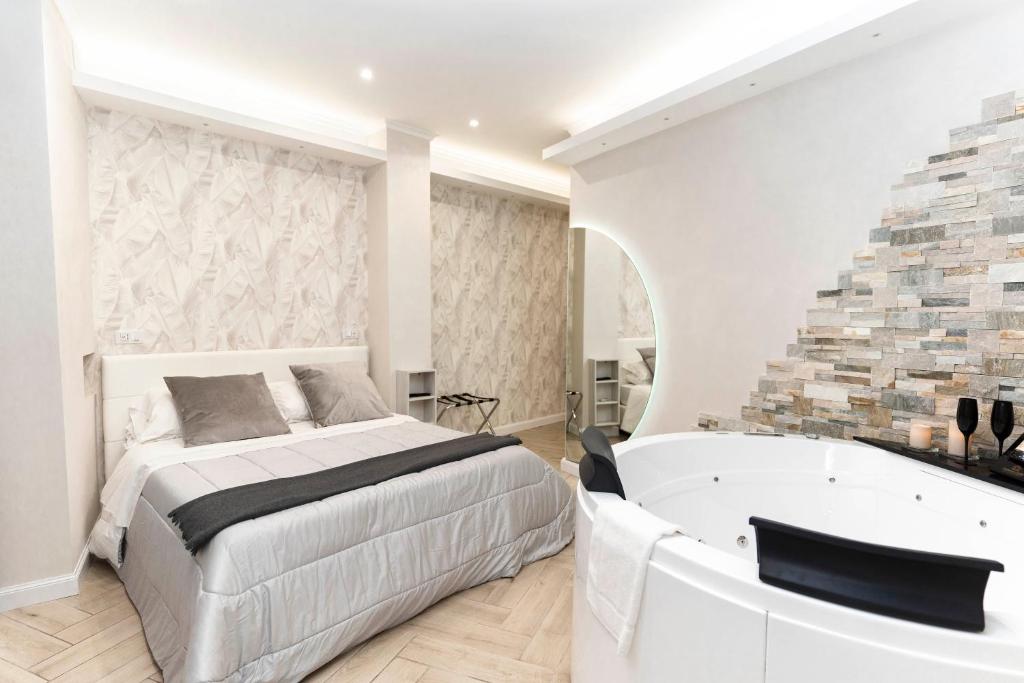 a bedroom with a king sized bed and a bath tub at Silver Suite Coliseum in Rome
