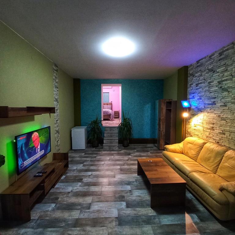 a living room with a couch and a tv at Старата Лоза in Montana