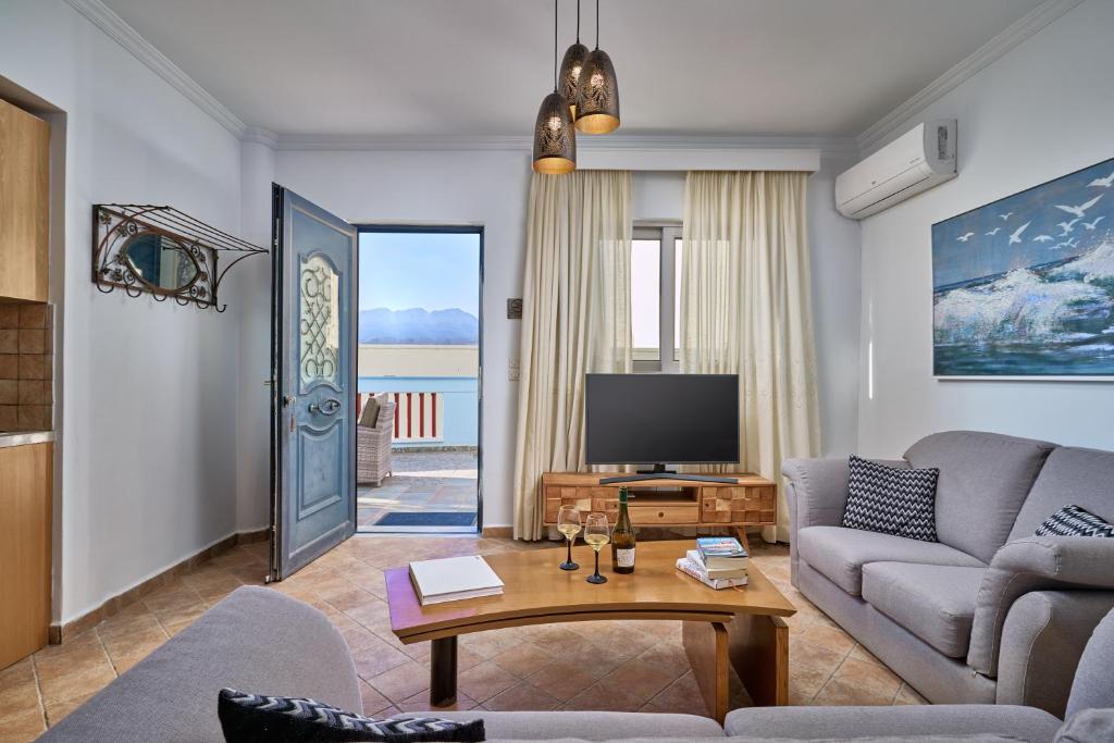 a living room with a couch and a tv at Al Centro Pigadia-Althea Homes in Karpathos Town
