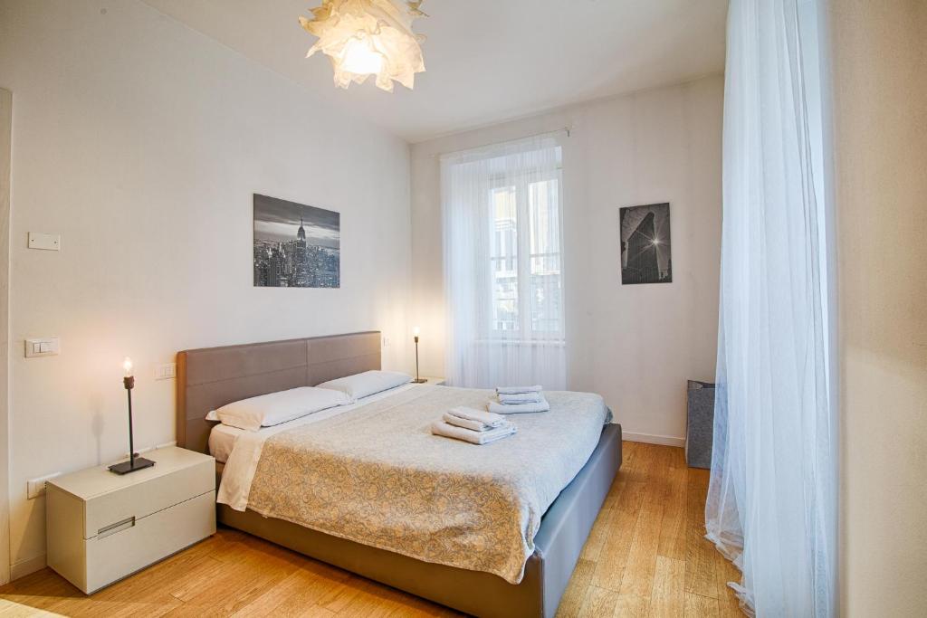 a bedroom with a bed and a chandelier at Scala al Belvedere in Trieste