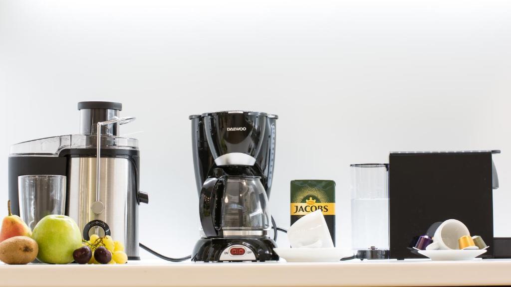 a kitchen counter with a blender and fruit on it at Nidus 101 in Souda