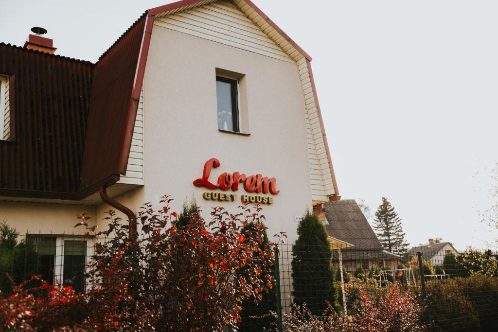 a sign on the side of a guest house at Guest House Lorem in Daugavpils