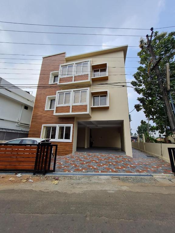 a house with a large driveway in front of it at Nimet Residency in Ernakulam