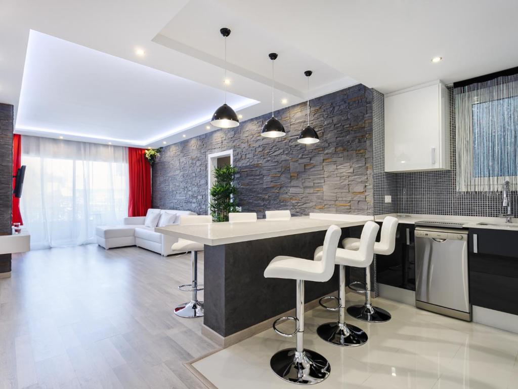 a kitchen with a counter and stools in a room at Beautiful apartment in the center equipped for 7 in Barcelona