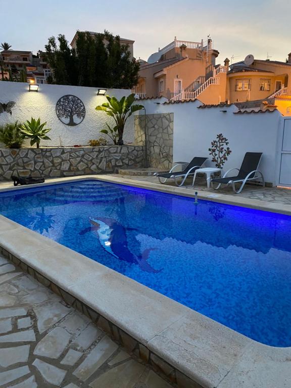 a swimming pool in a villa with a house at Casa di Paddy in Ciudad Quesada