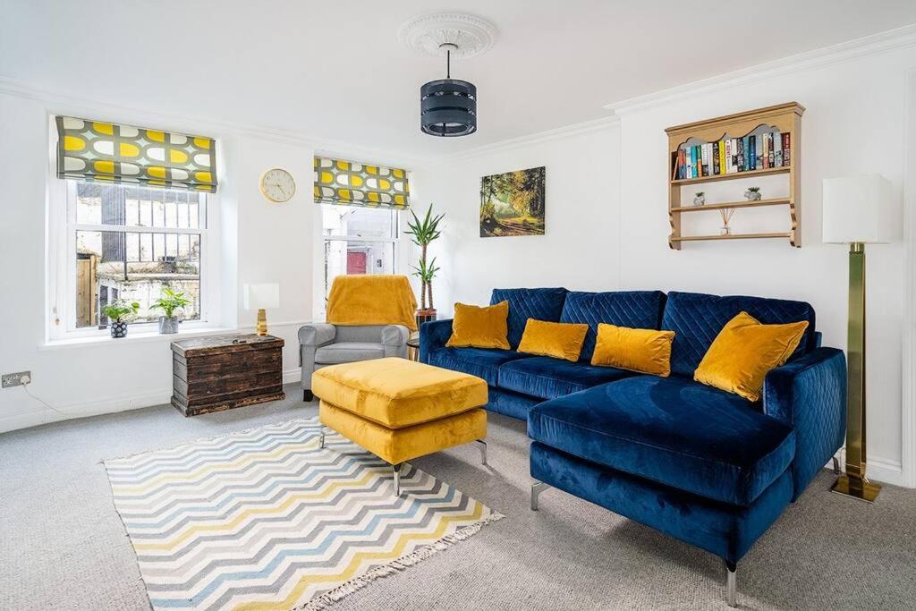 a living room with a blue couch and yellow pillows at BRAND NEW LSITING!Wonderful One Bedroom Apartment in Bath