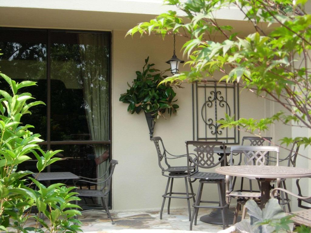 a patio with a table and chairs and a window at Sonesta Atlanta Airport North in Atlanta