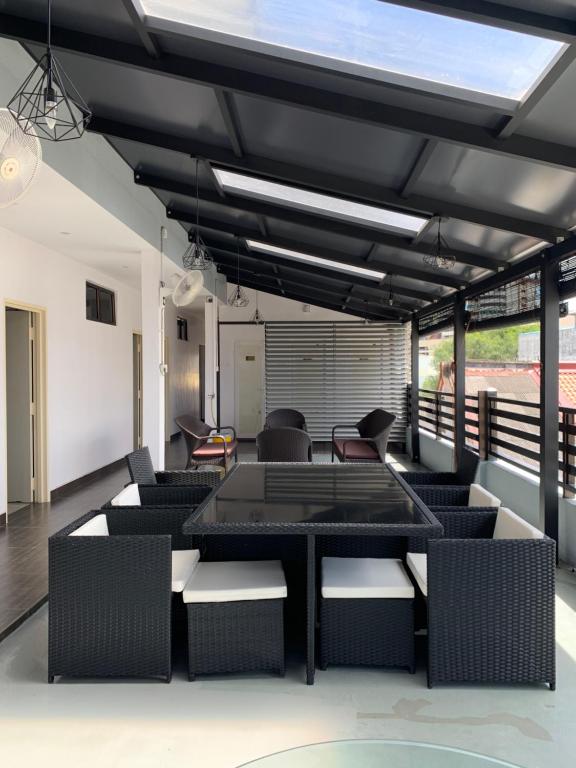 a living room with chairs and a table and a balcony at Hotel Decentraland Kuala Terengganu in Kuala Terengganu