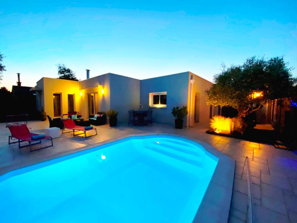 a swimming pool in front of a house at Chez Victoria Nantes Erdre in Nantes