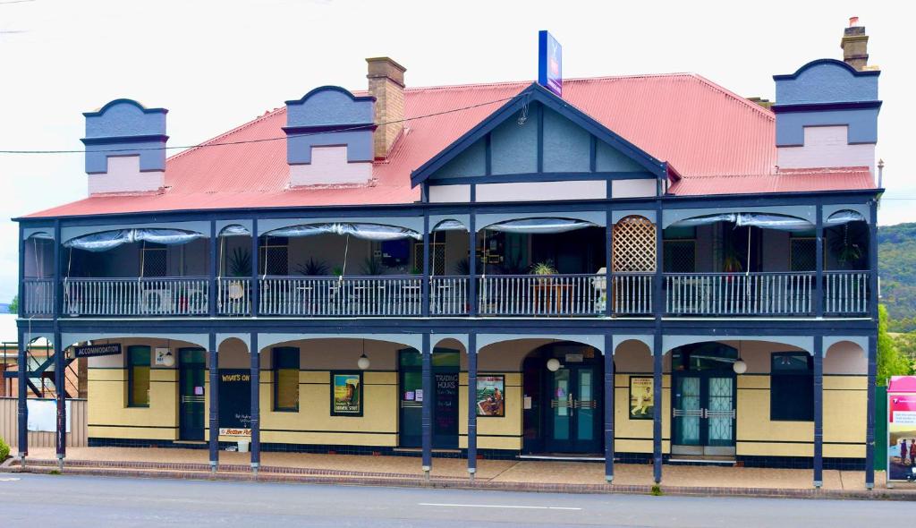 a blue and yellow building with a red roof at The Commercial Hotel Wallerawang in Wallerawang