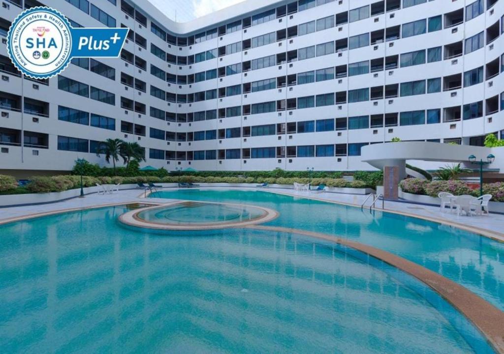 a large swimming pool in front of a large building at Asia Airport Hotel in Bangkok