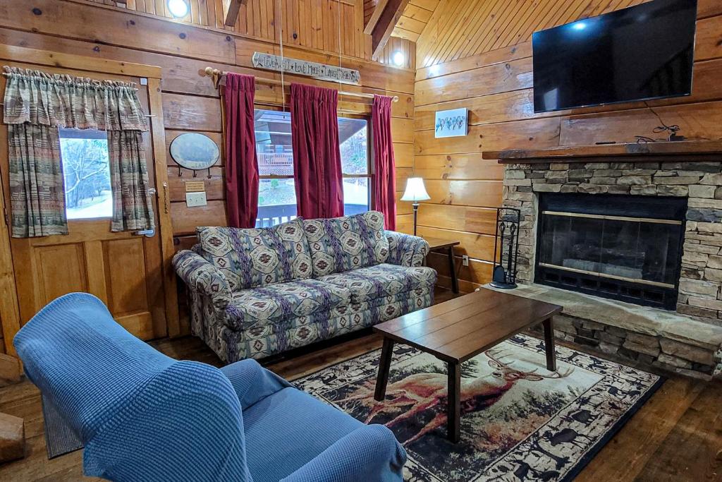a living room with a couch and a fireplace at Smokies Retreat in Sevierville