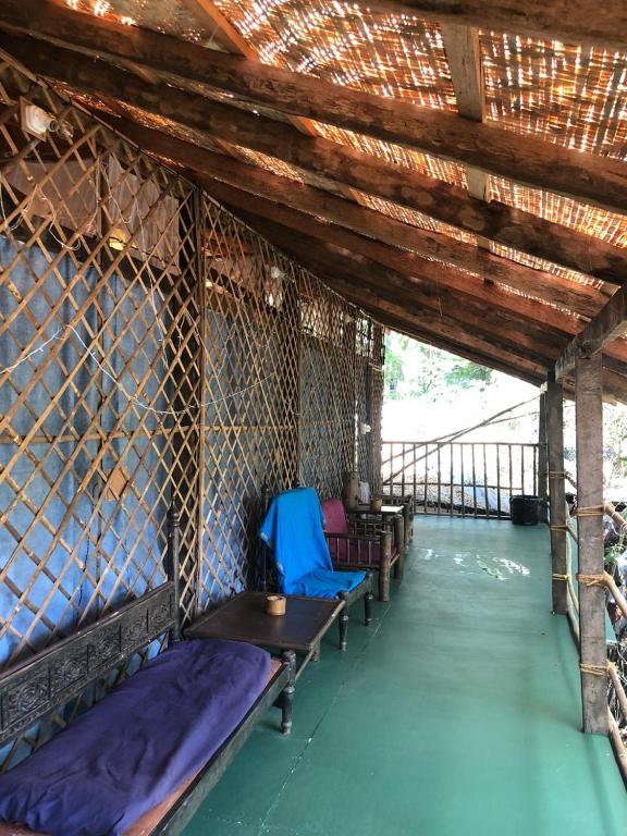 a room with a table and chairs in a building at Bhakti Kutir in Palolem