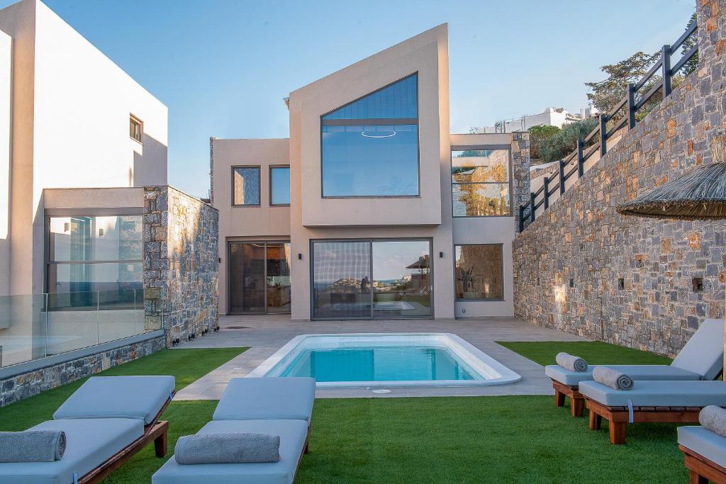 a house with a swimming pool in the yard at Ligaria Mare in Agia Pelagia