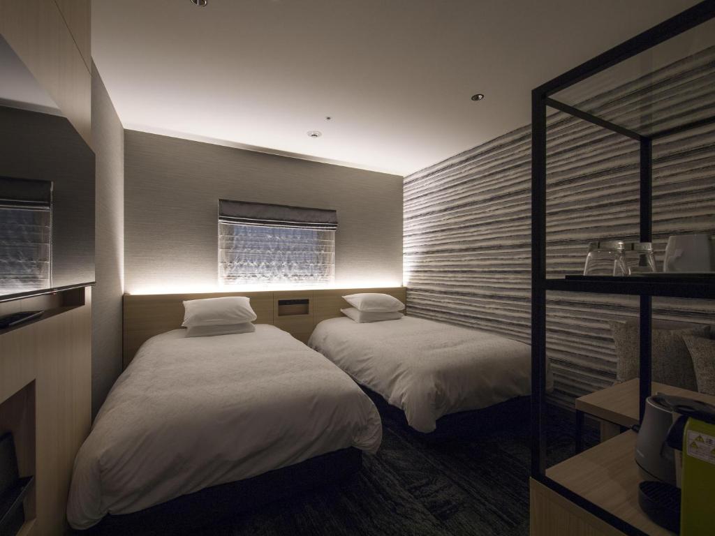 Postel nebo postele na pokoji v ubytování Tmark City Hotel Kanazawa