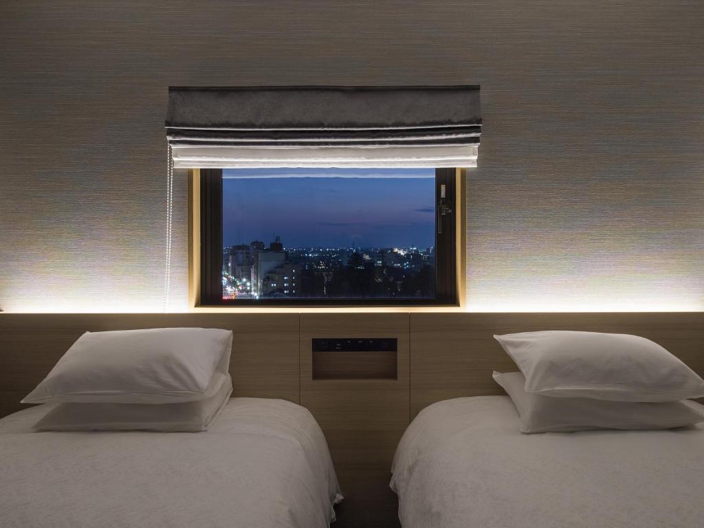 Postel nebo postele na pokoji v ubytování Tmark City Hotel Kanazawa