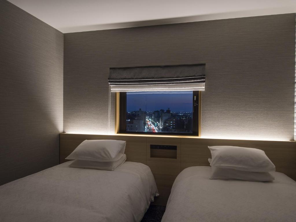 Postel nebo postele na pokoji v ubytování Tmark City Hotel Kanazawa