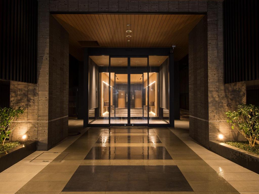 a hallway of a building with glass doors at Tmark City Hotel Kanazawa in Kanazawa