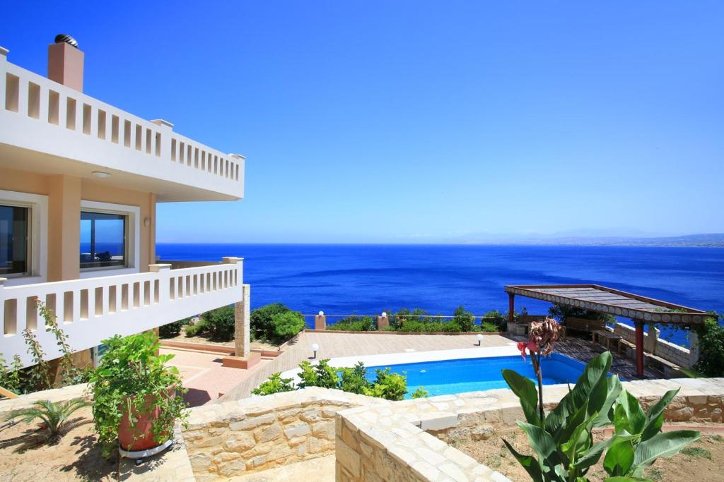 a villa with a view of the ocean at Villa Diktynna - Embrace the endless blue in Heraklio