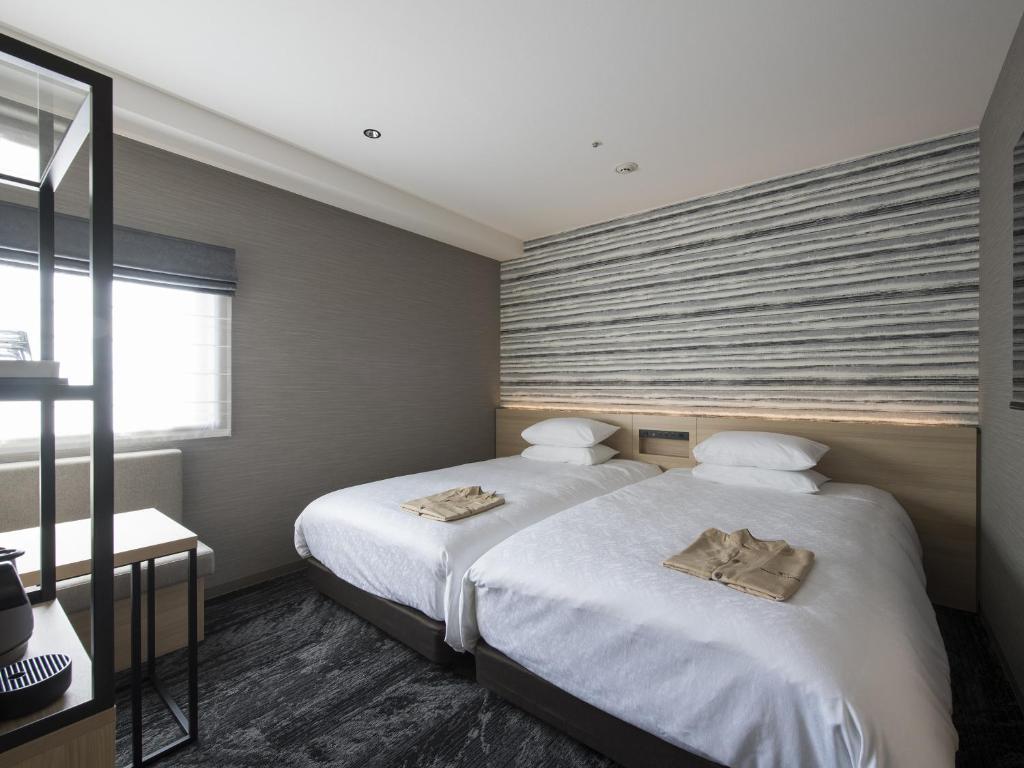 Postel nebo postele na pokoji v ubytování Tmark City Hotel Kanazawa