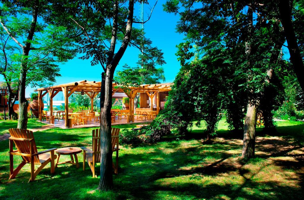 a wooden pavilion with a table and chairs in a park at Belconti Resort Hotel in Belek