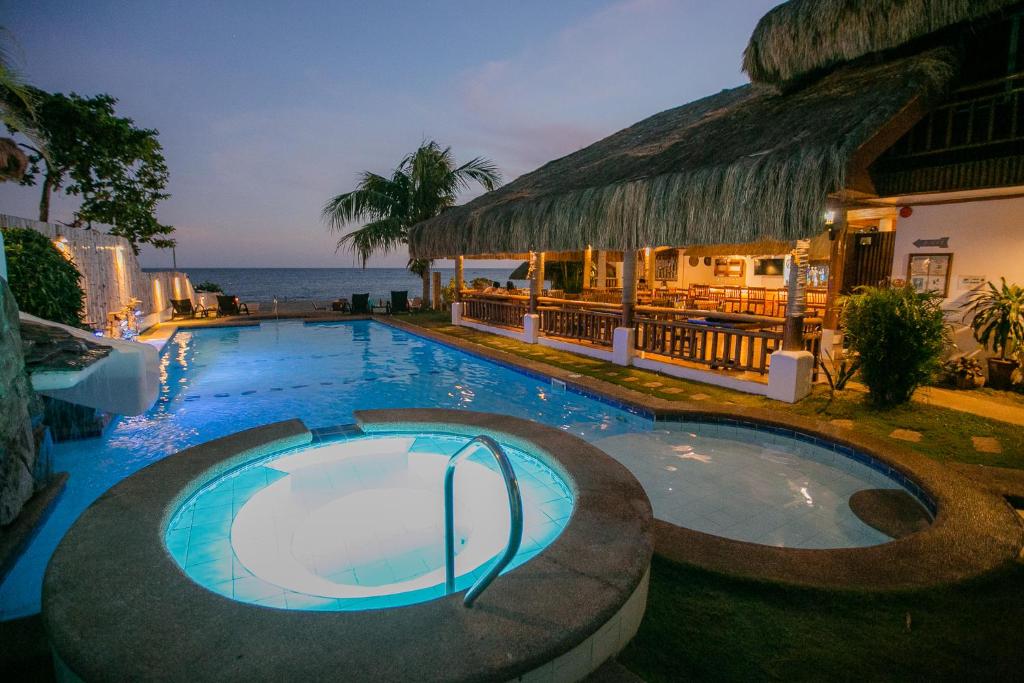 a swimming pool in front of a resort at Kav's Beach Resort in Zamboanguita