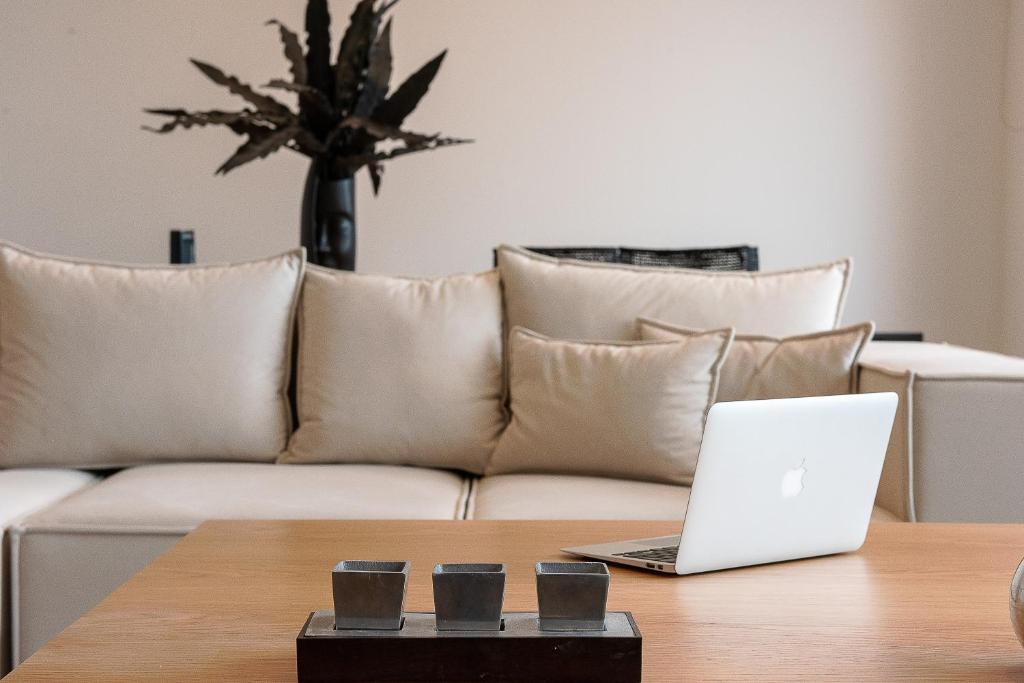 a laptop sitting on a table in front of a couch at Ligaria Mare in Agia Pelagia