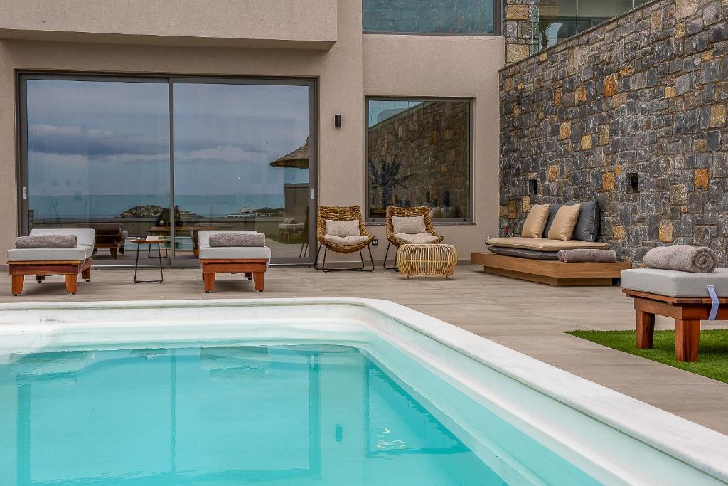 a swimming pool in front of a house at Ligaria Mare in Agia Pelagia