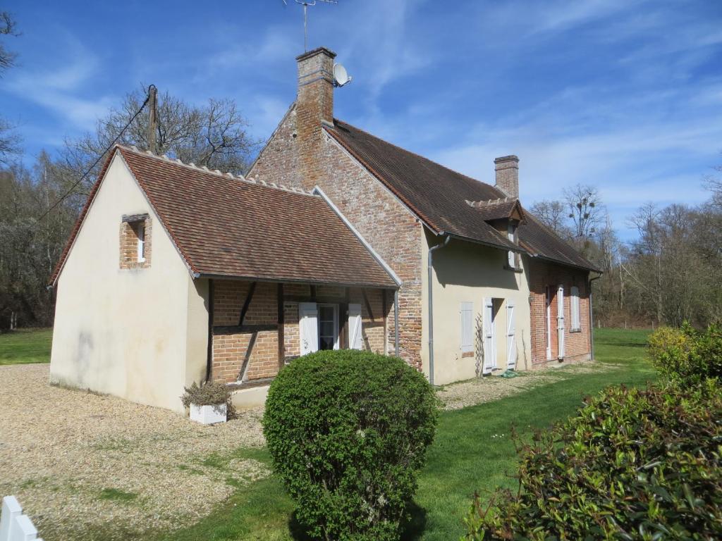 ein altes Backsteinhaus mit Dach in der Unterkunft La Ferme de Montboulan in Salbris