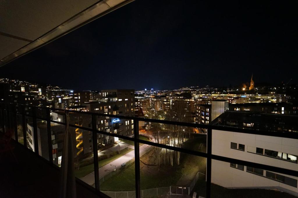 a view of a city at night from a balcony at CITY CENTER Penthouse apartment in Oslo