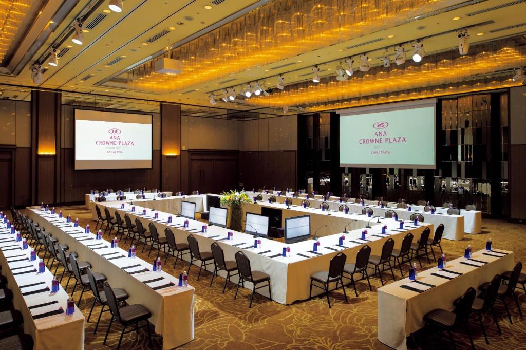 a large banquet hall with white tables and chairs at ANA Crowne Plaza Kanazawa by IHG in Kanazawa