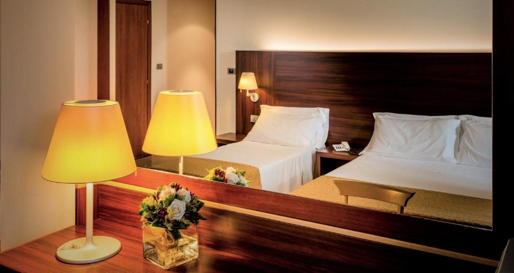 Postel nebo postele na pokoji v ubytování Delfina Palace Hotel
